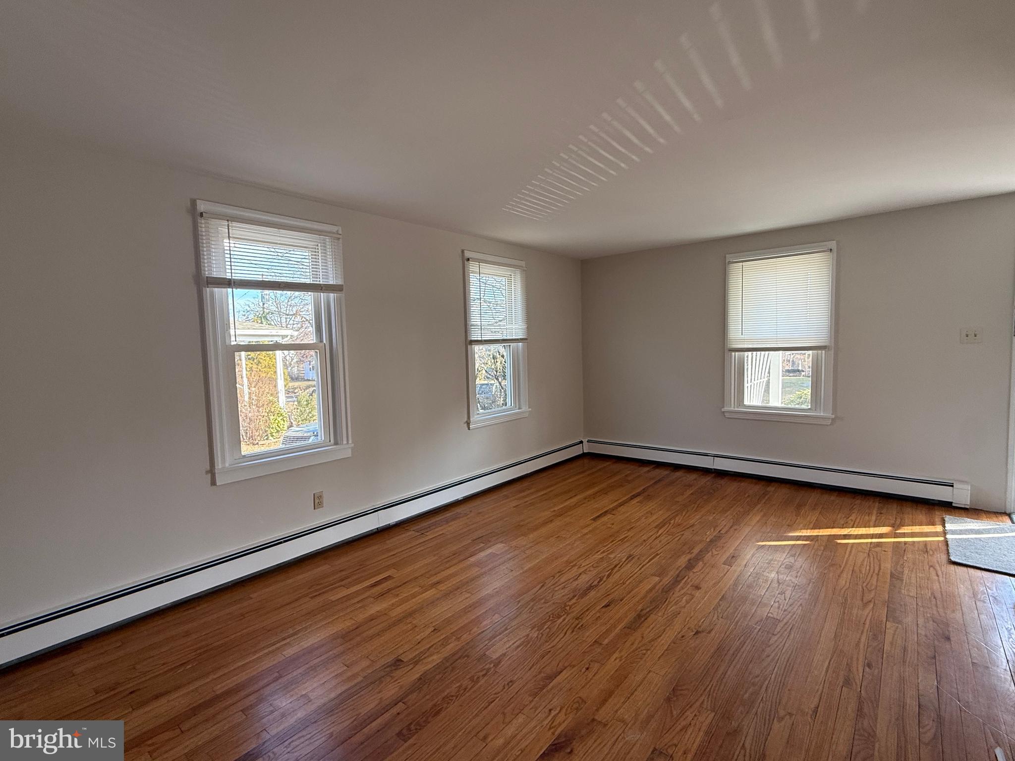 121 East Harmony Road West Grove, PA 19390 - Photo 18 of 50 a view of an empty room with wooden floor and window