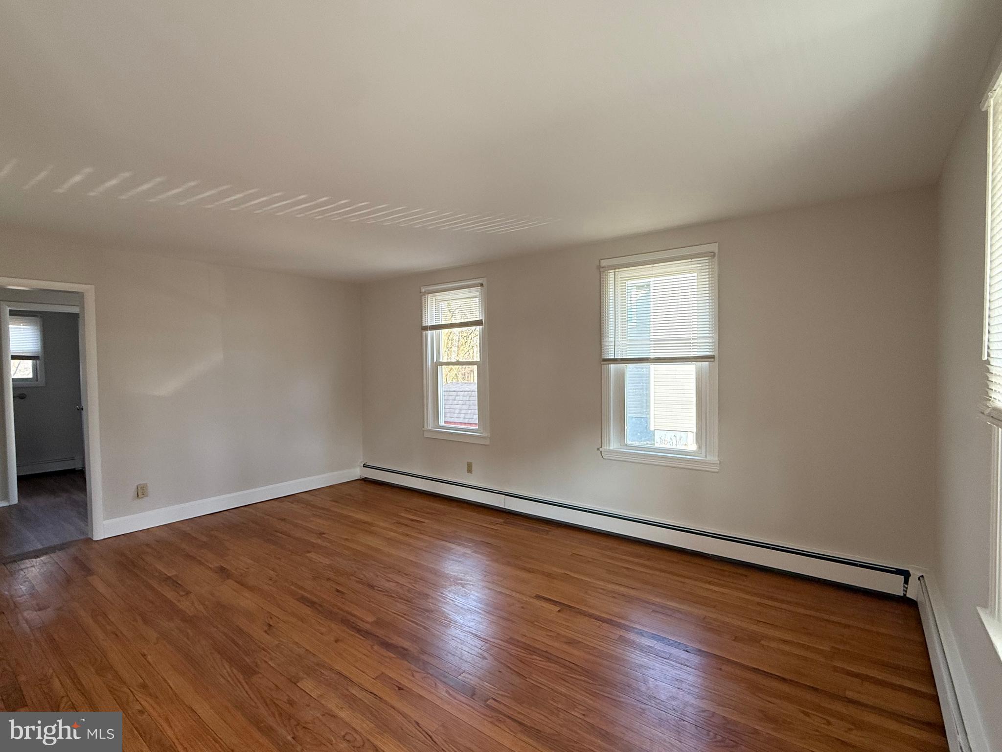 121 East Harmony Road West Grove, PA 19390 - Photo 22 of 50 an empty room with wooden floor and windows