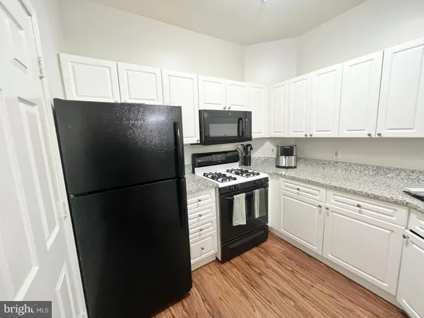 a kitchen with a refrigerator stove and sink