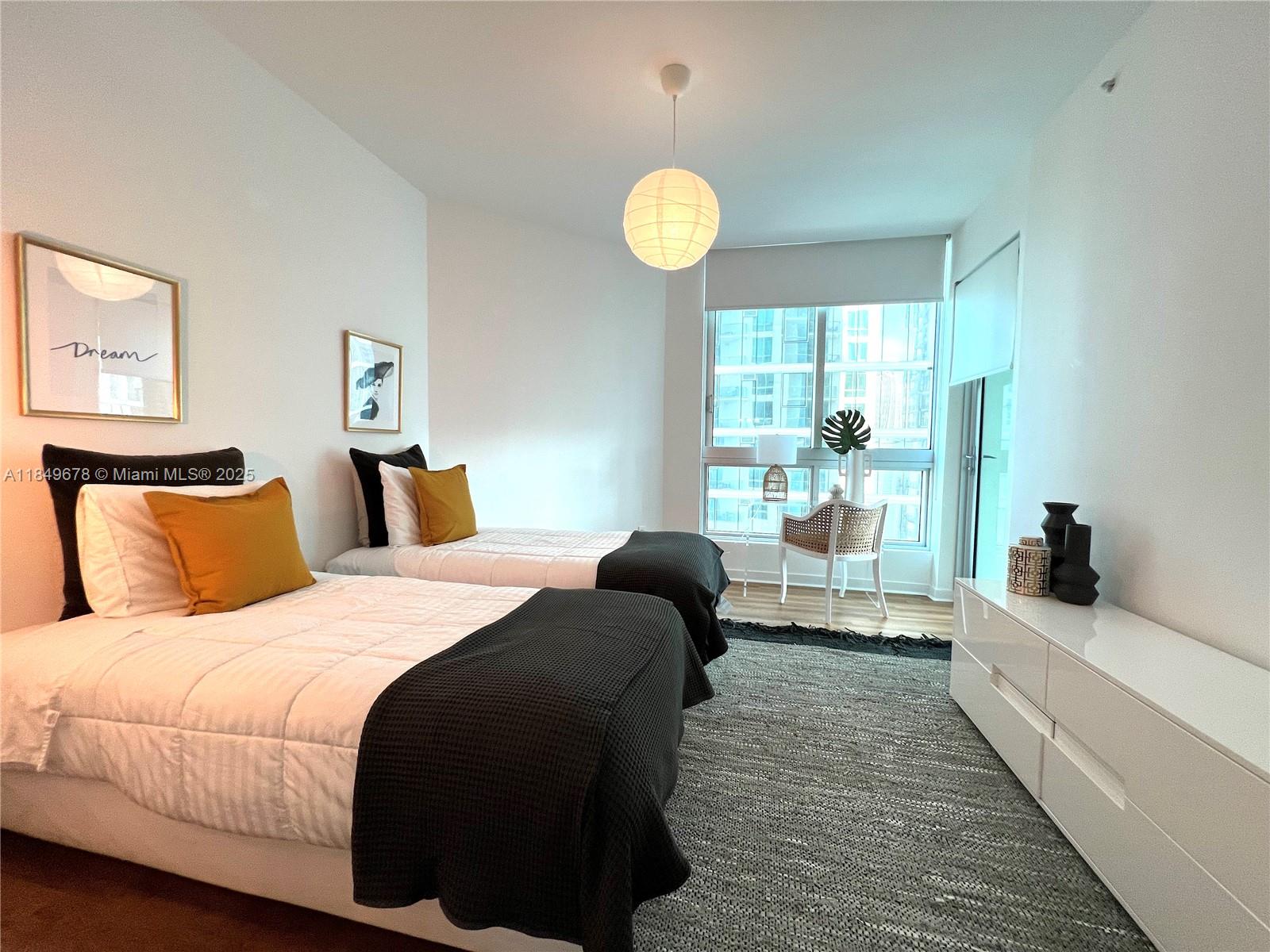 300 South Biscayne Boulevard, Unit T1602 Miami, FL 33131 - Photo 14 of 20 a bedroom with a bed and a large window