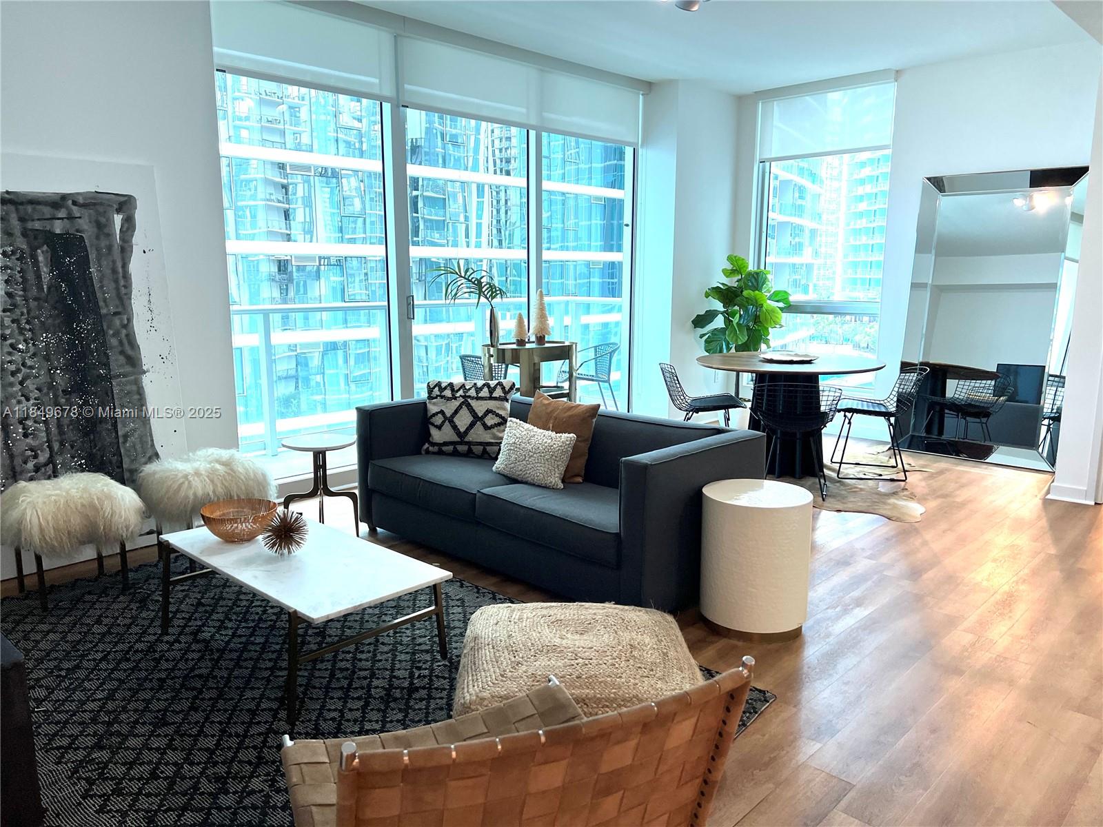 300 South Biscayne Boulevard, Unit T1602 Miami, FL 33131 - Photo 2 of 20 a living room with furniture and a potted plant