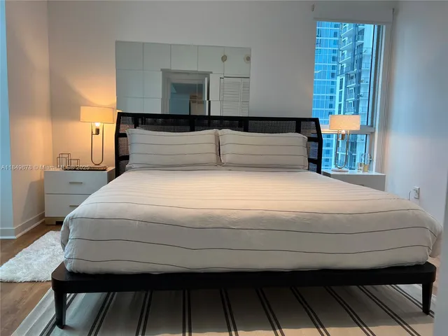 a bedroom with a bed and window