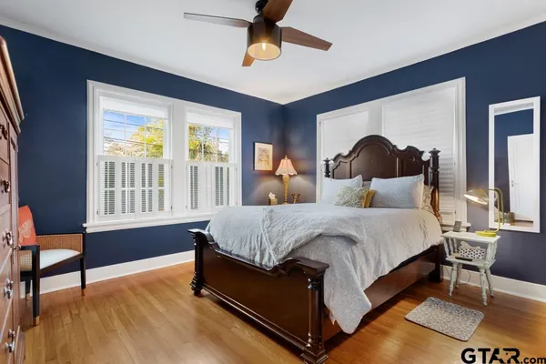 a bed sitting in a bedroom next to a window