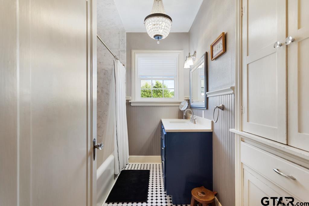 107 Rowland Place Tyler, TX 75701 - Photo 14 of 42 a bathroom with a sink a toilet and a mirror