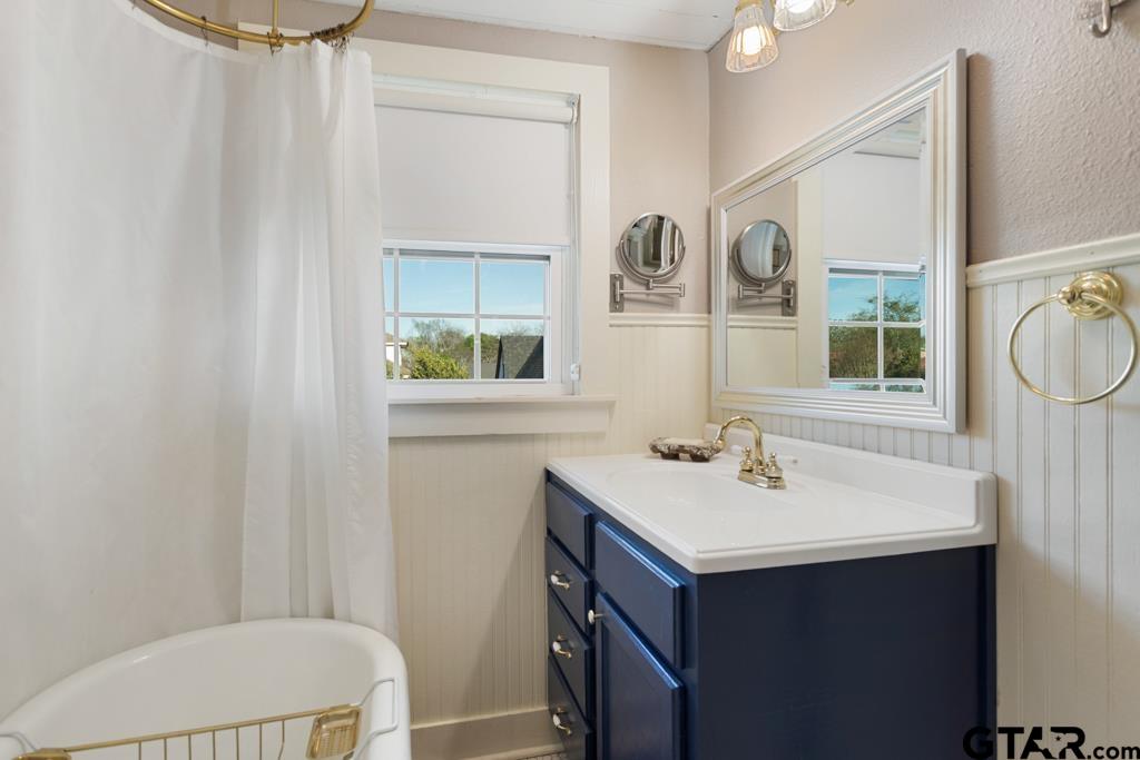 107 Rowland Place Tyler, TX 75701 - Photo 19 of 42 a bathroom with a sink vanity mirror and toilet