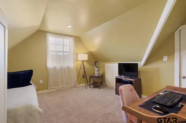 a living room with furniture a piano and a flat screen tv