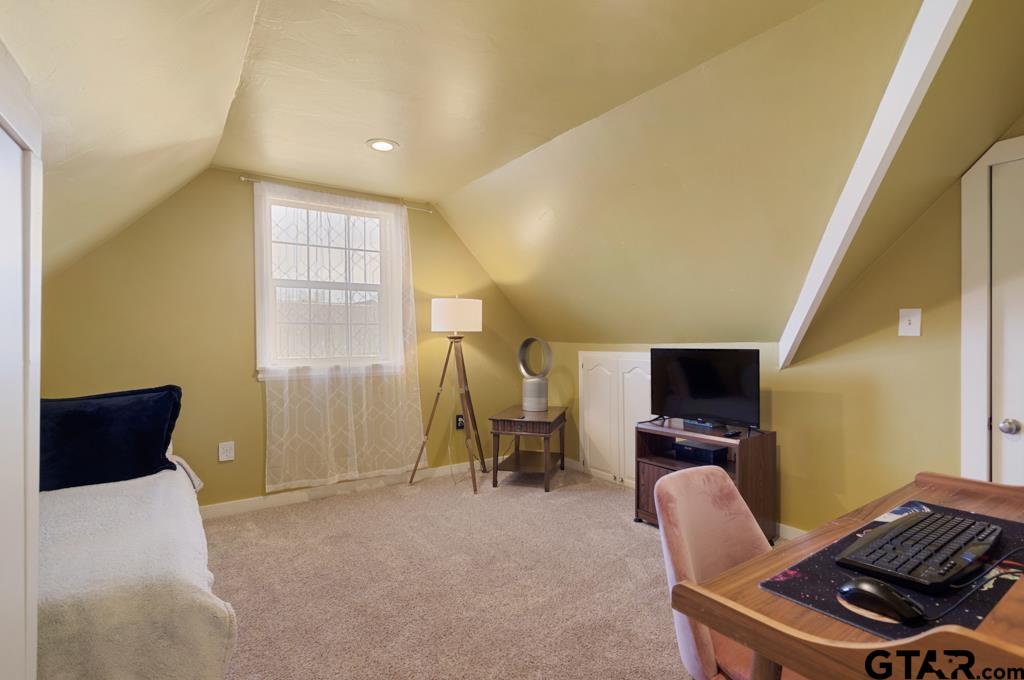 107 Rowland Place Tyler, TX 75701 - Photo 20 of 42 a living room with furniture a piano and a flat screen tv