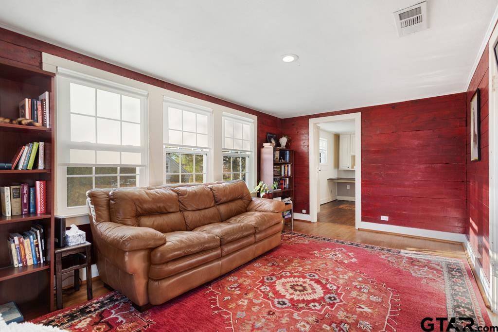 107 Rowland Place Tyler, TX 75701 - Photo 22 of 42 a living room with furniture and a book shelf