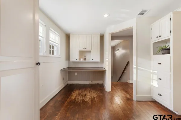 a view of room with window and wooden floor