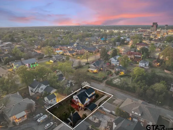 an aerial view of residential house with yard and mountain view in back