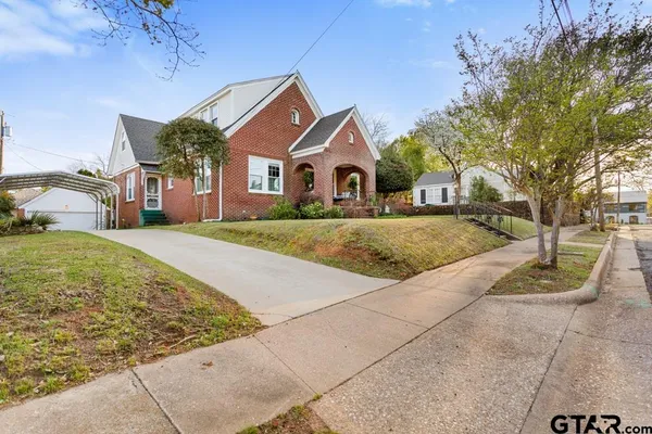 a front view of a house with garden