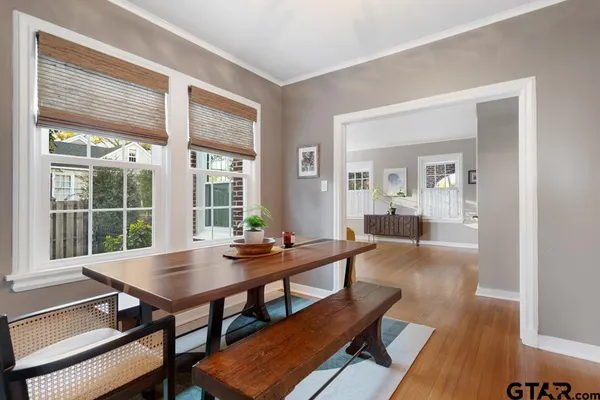 a view of a dining room with furniture wooden floor and a rug