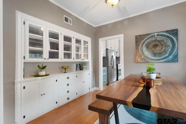 a view of a kitchen area with furniture and wooden floor