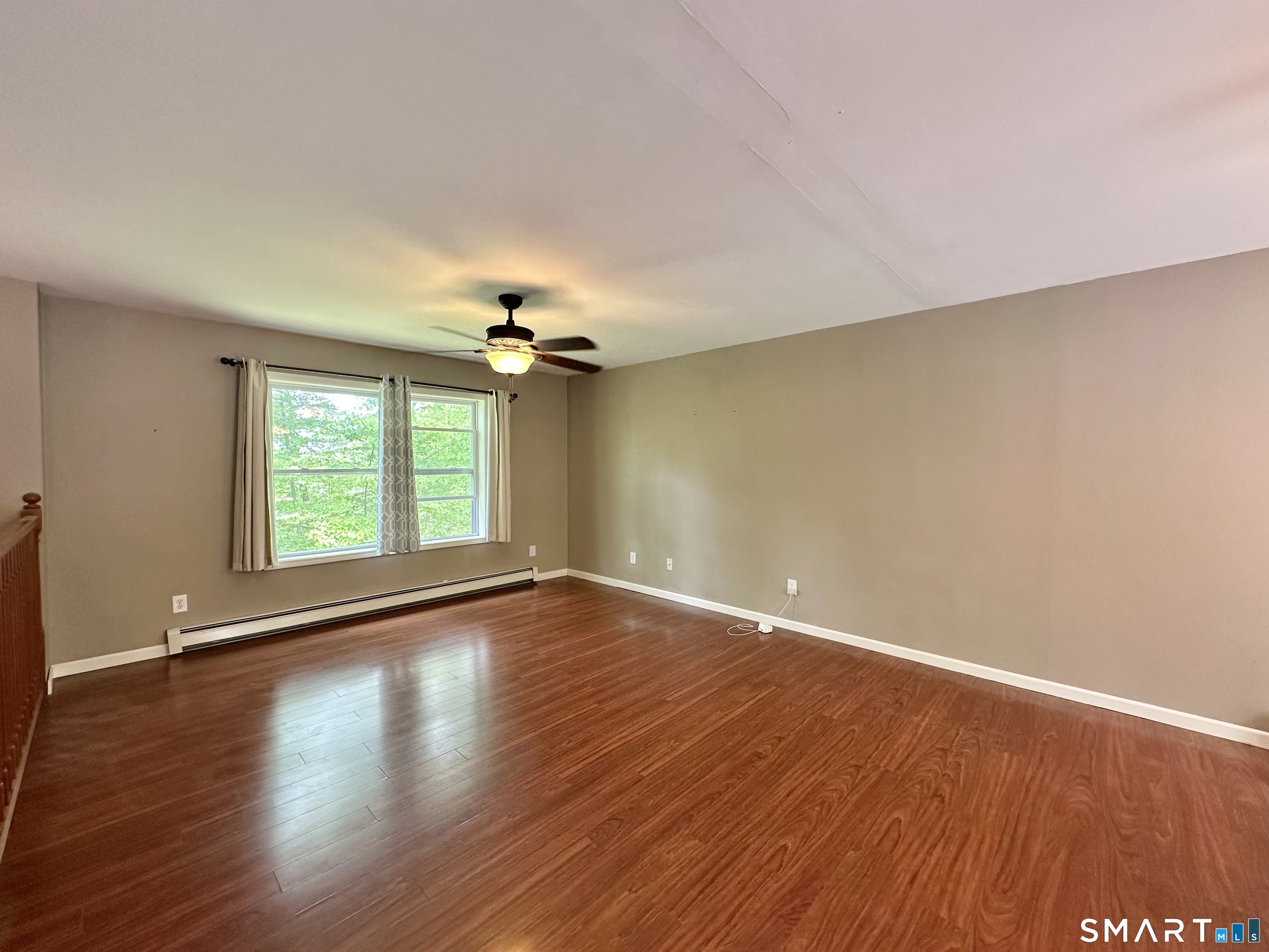 116 Tatnic Hill Road Brooklyn, CT 06234 - Photo 13 of 27 a view of an empty room with wooden floor and a window
