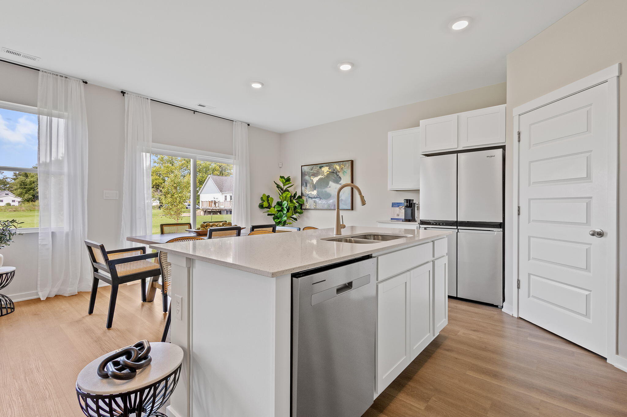 433 Fry Street Hebron, IN 46341 - Photo 3 of 24 a kitchen with refrigerator cabinets and a table