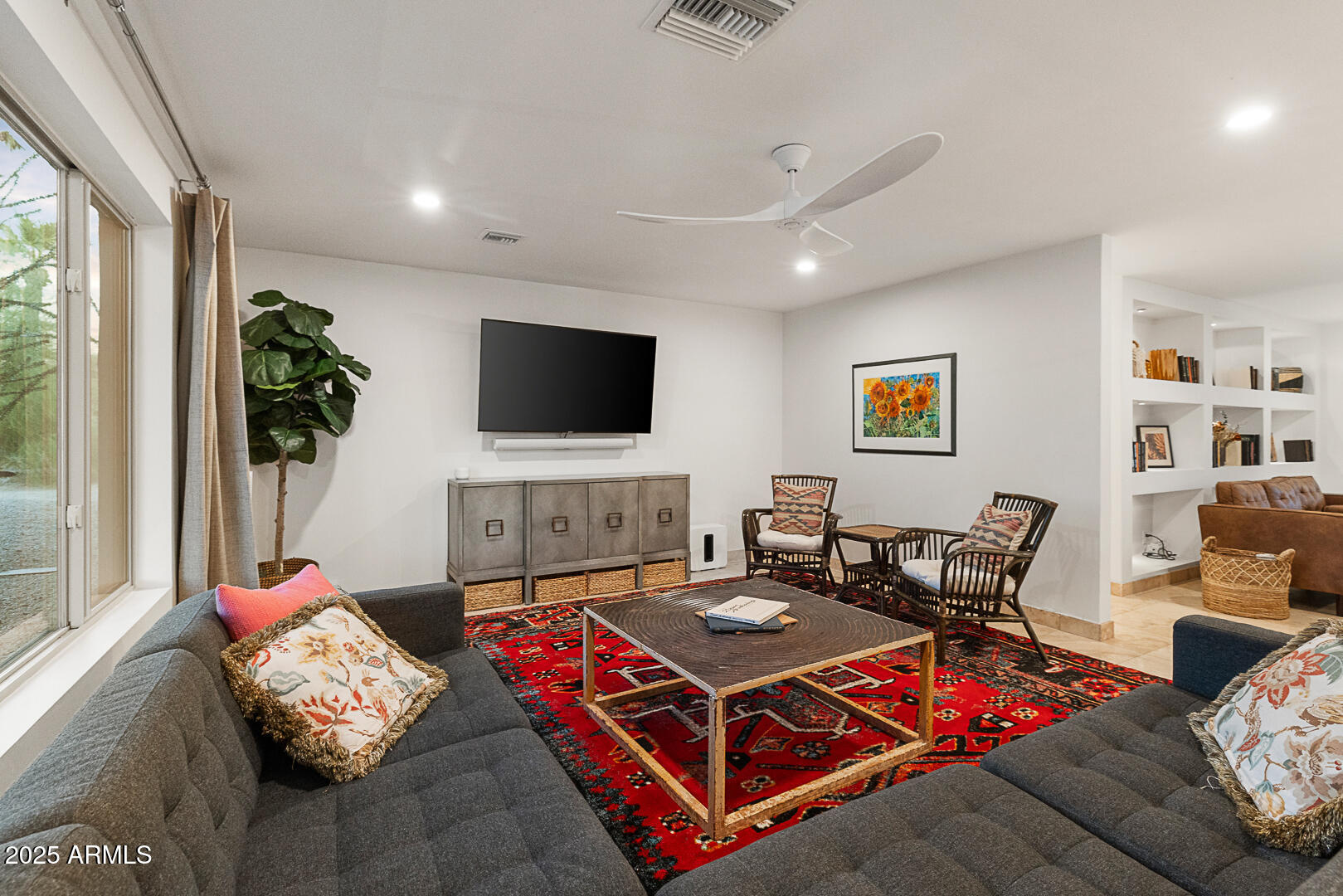 8433 East Cholla Street Scottsdale, AZ 85260 - Photo 12 of 29 a living room with furniture and a flat screen tv