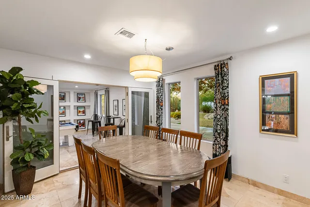 a living room with furniture and a book shelf