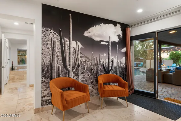 a spacious bedroom with a bed a couch and a flat tv screen