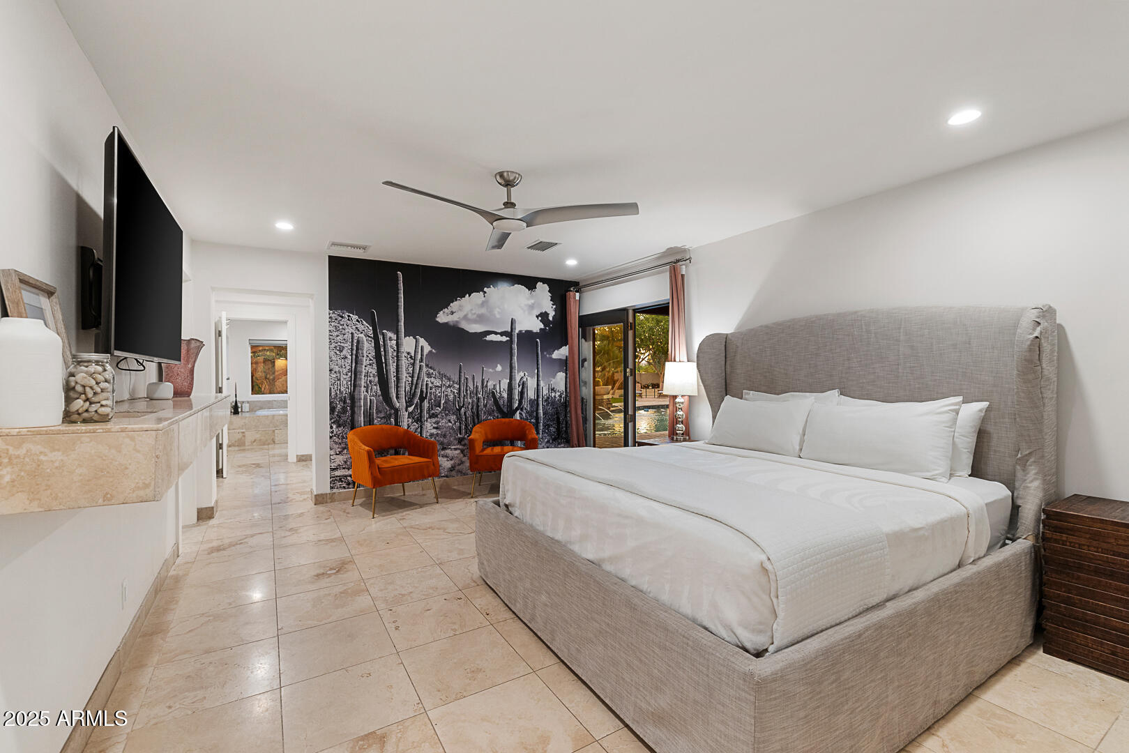 8433 East Cholla Street Scottsdale, AZ 85260 - Photo 18 of 29 a spacious bedroom with a bed a couch and a flat tv screen