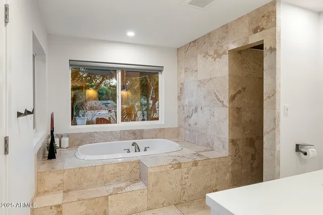a bathroom with a toilet a sink and shower