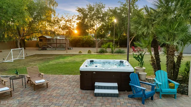 a view of a swimming pool and lounge chairs in back yard