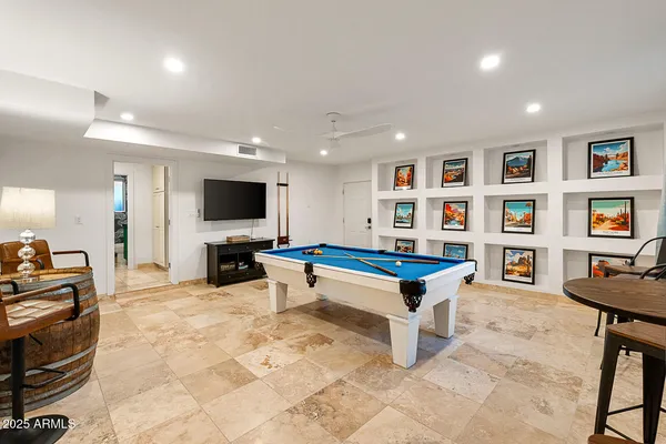 a kitchen with granite countertop kitchen island stainless steel appliances a sink stove and refrigerator