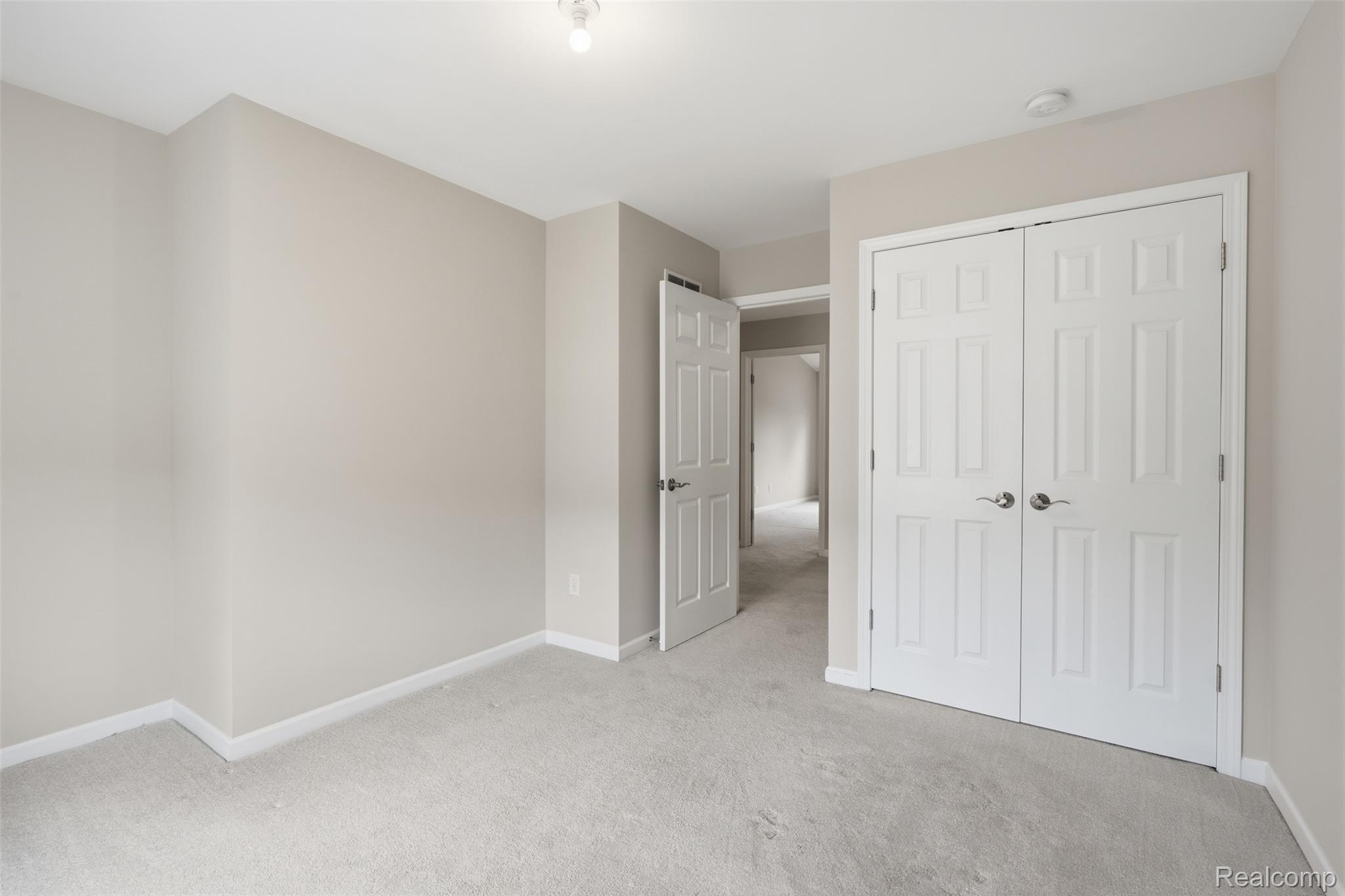 41594 Mitchell Road Novi, MI 48377 - Photo 23 of 35 Unfurnished bedroom featuring light colored carpet and baseboards