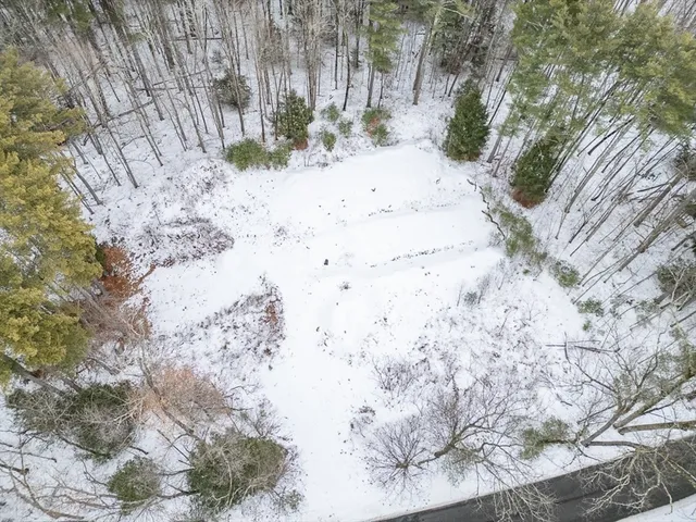a view of white house with a snow in the background