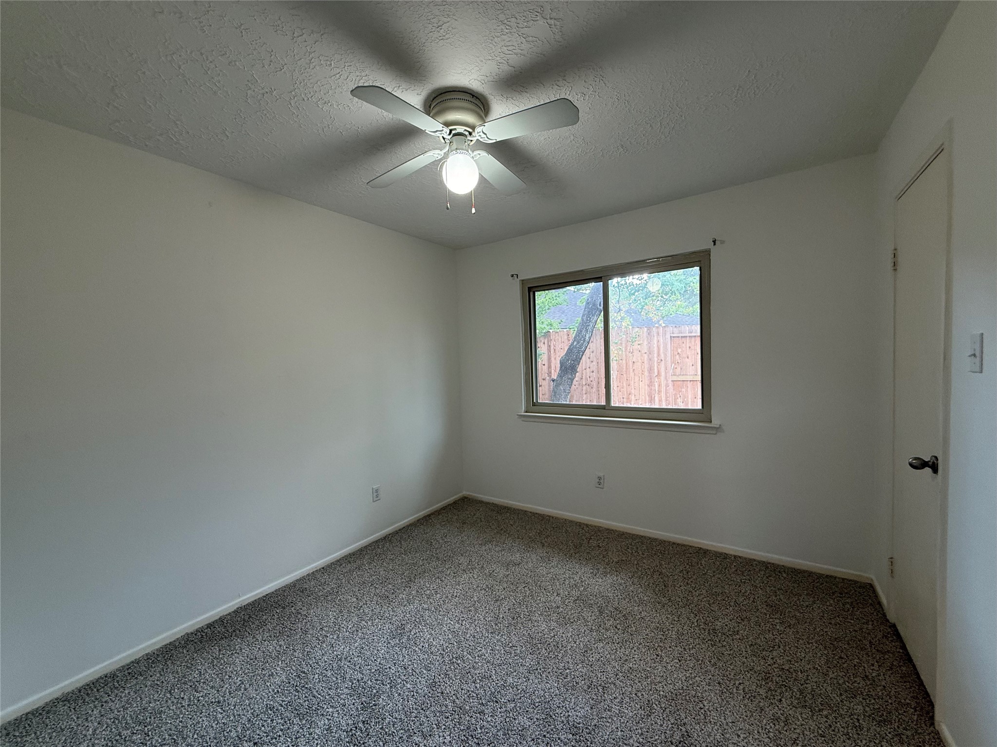 4722 Enchanted Rock Lane Spring, TX 77388 - Photo 11 of 22 an empty room with windows and fan