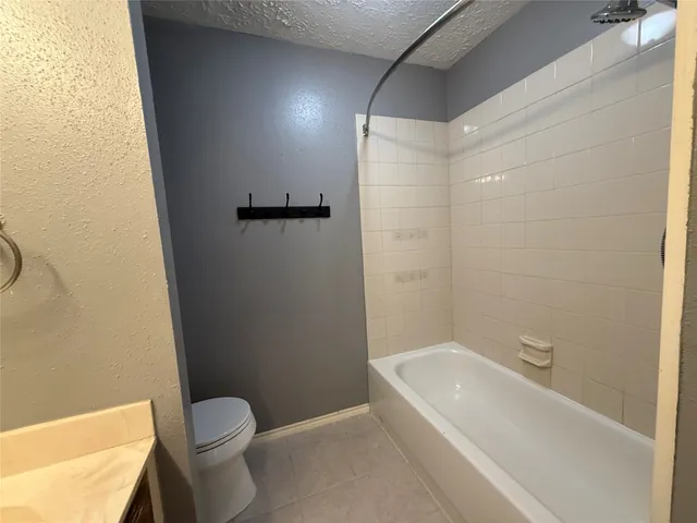 a bathroom with a bathtub and toilet