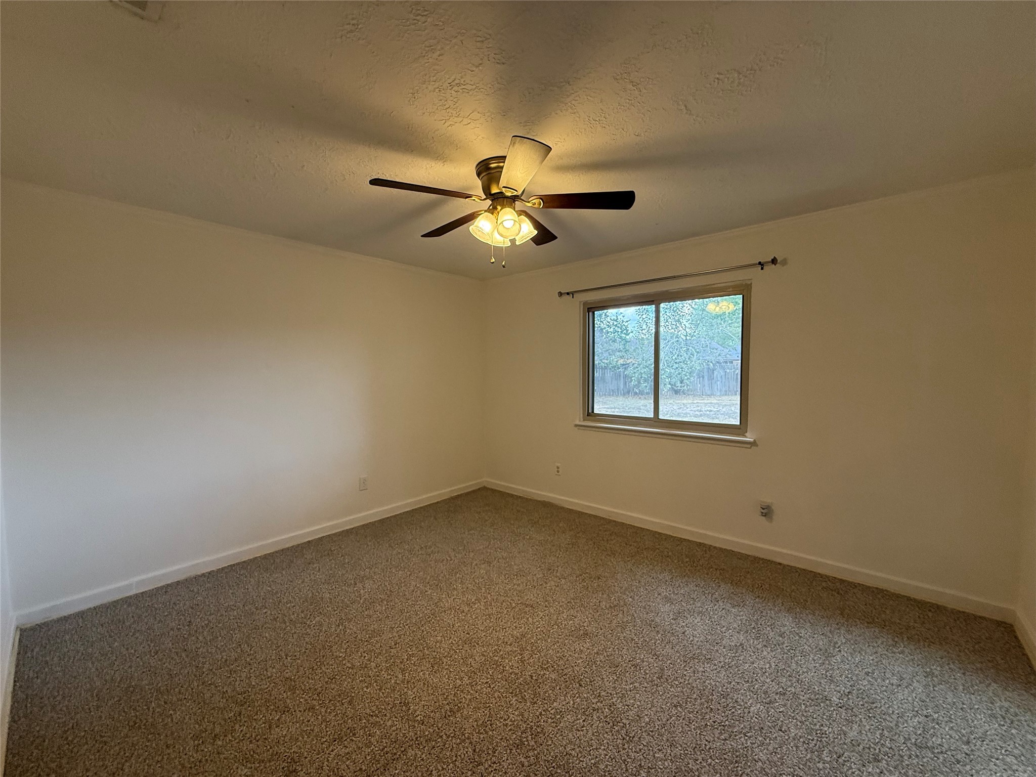 4722 Enchanted Rock Lane Spring, TX 77388 - Photo 6 of 22 an empty room with a window and a ceiling fan