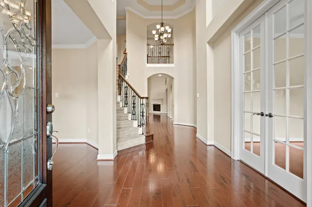 a view of a hallway with wooden floor and staircase