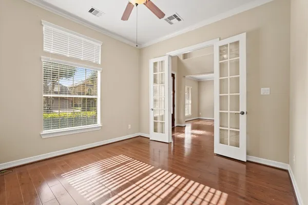 wooden floor in an empty room with a window