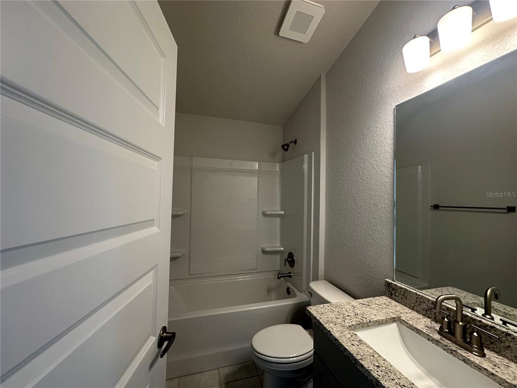 4413 Southwest 90th Place Ocala, FL 34476 - Photo 14 of 17 a bathroom with a sink a toilet and shower