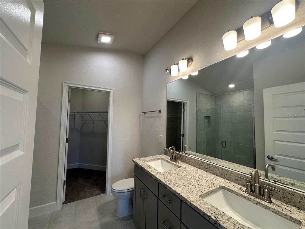4413 Southwest 90th Place Ocala, FL 34476 - Photo 9 of 17 a bathroom with a double vanity sink and a mirror