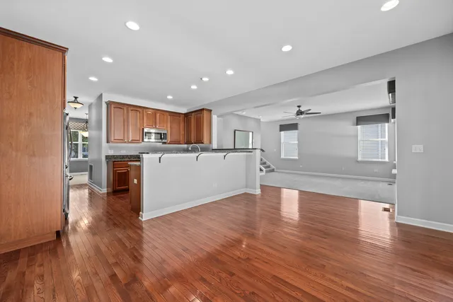 a view of kitchen with wooden floor and electronic appliances