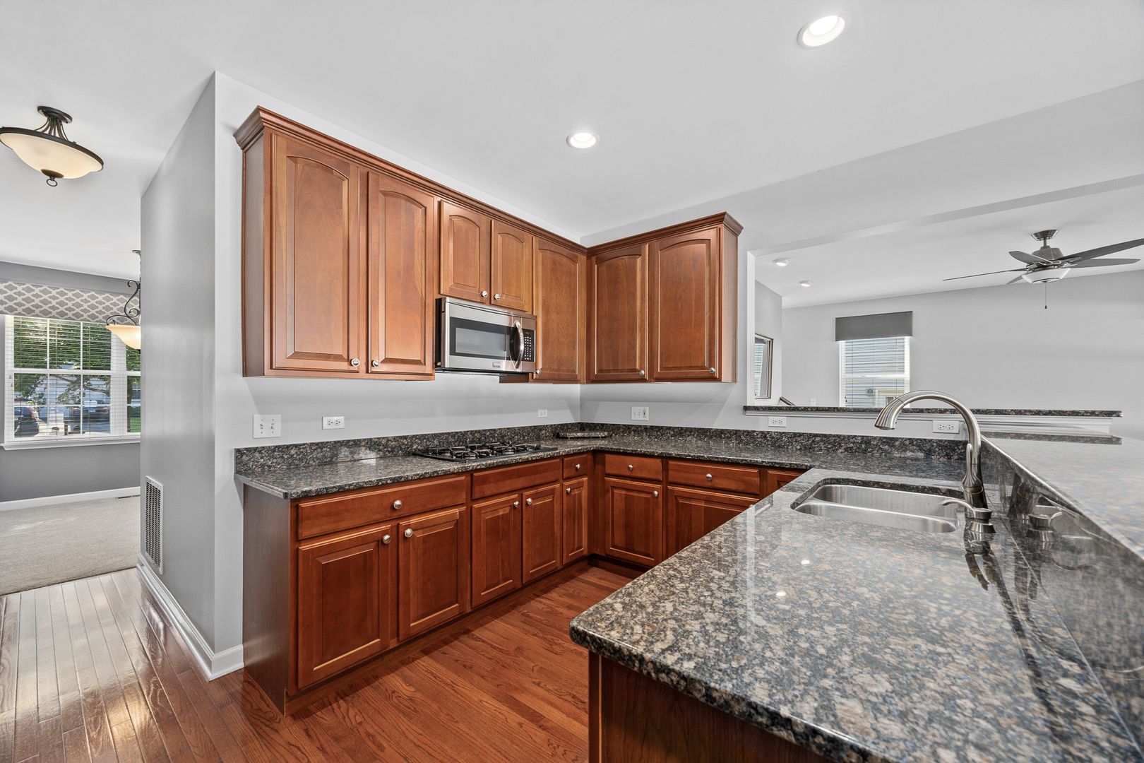 725 Delacourte Avenue Bolingbrook, IL 60490 - Photo 14 of 38 a kitchen with granite countertop a sink and cabinets