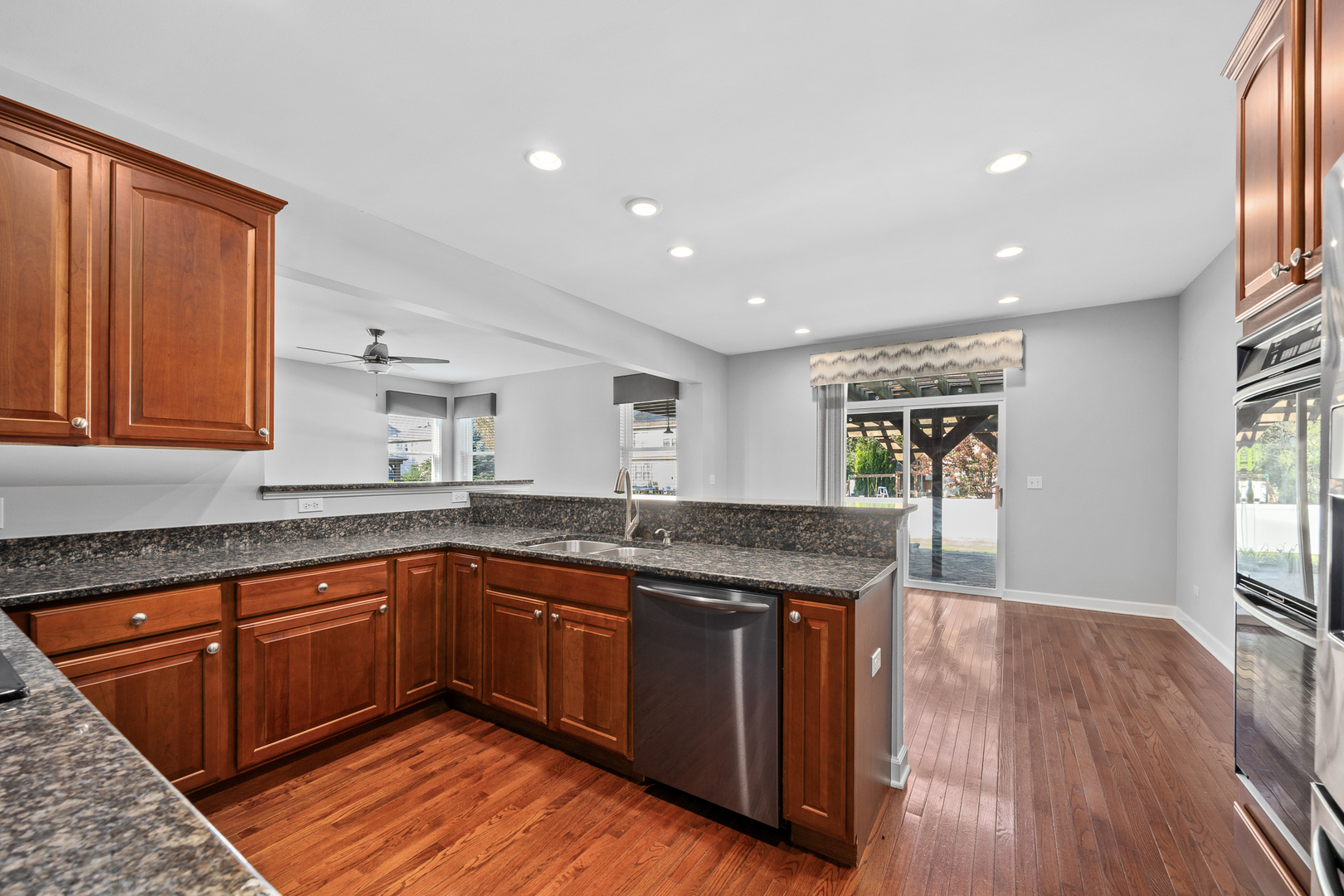 725 Delacourte Avenue Bolingbrook, IL 60490 - Photo 15 of 38 a kitchen with granite countertop sink stove and cabinets