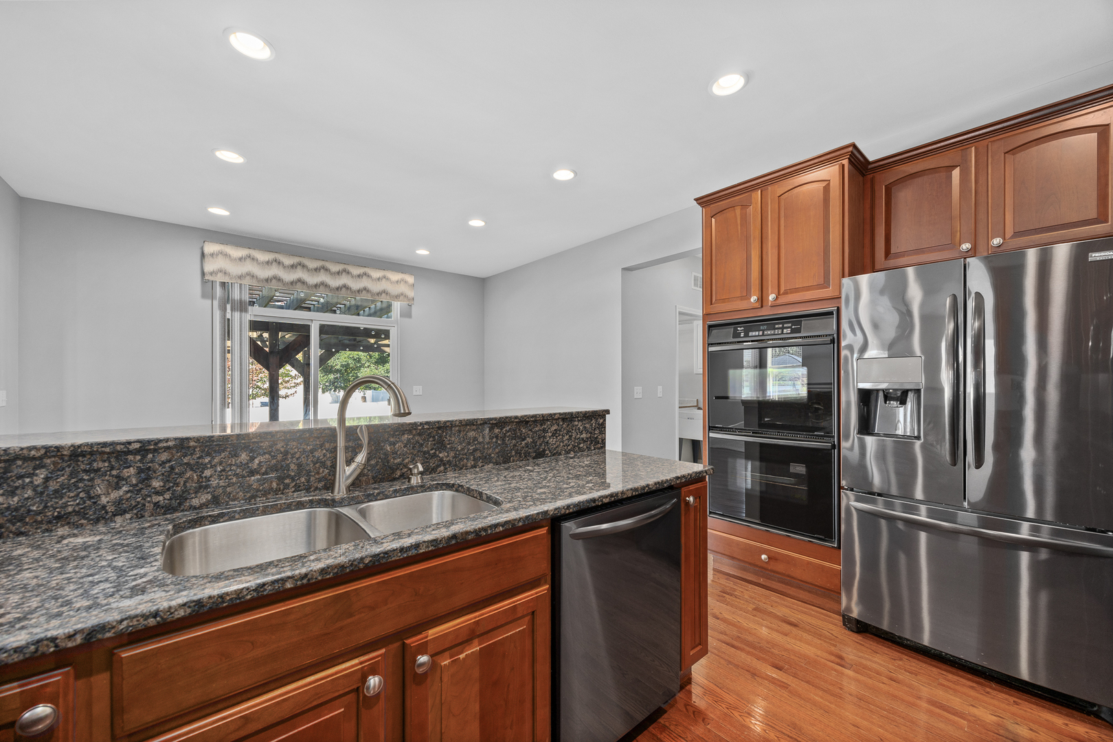 725 Delacourte Avenue Bolingbrook, IL 60490 - Photo 16 of 38 a kitchen with granite countertop a sink stove and refrigerator