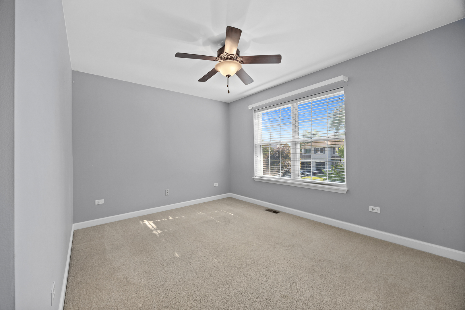 725 Delacourte Avenue Bolingbrook, IL 60490 - Photo 22 of 38 an empty room with windows and ceiling fan