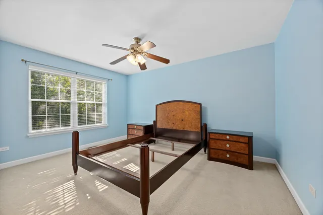a living room with furniture a window and a flat screen tv