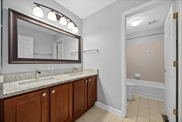 a bathroom with a sink vanity and a mirror