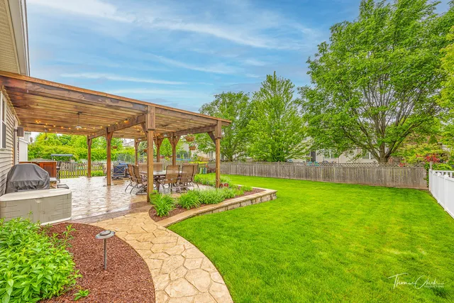 a view of a backyard with sitting area