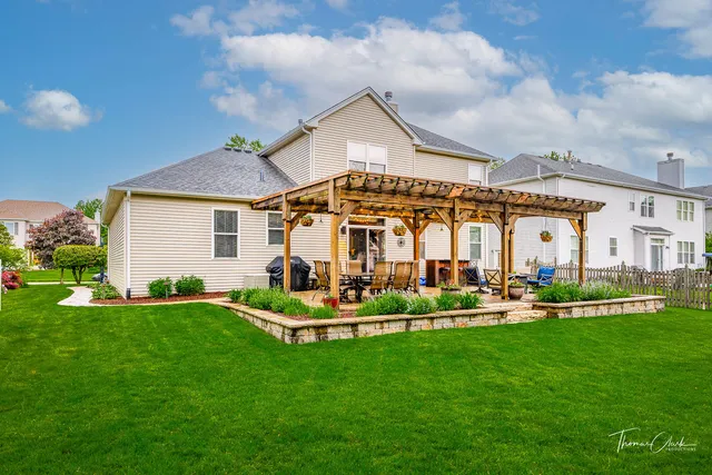a front view of a house with a garden and plants