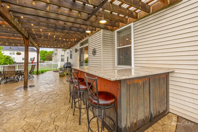 a view of a chairs and table in the patio