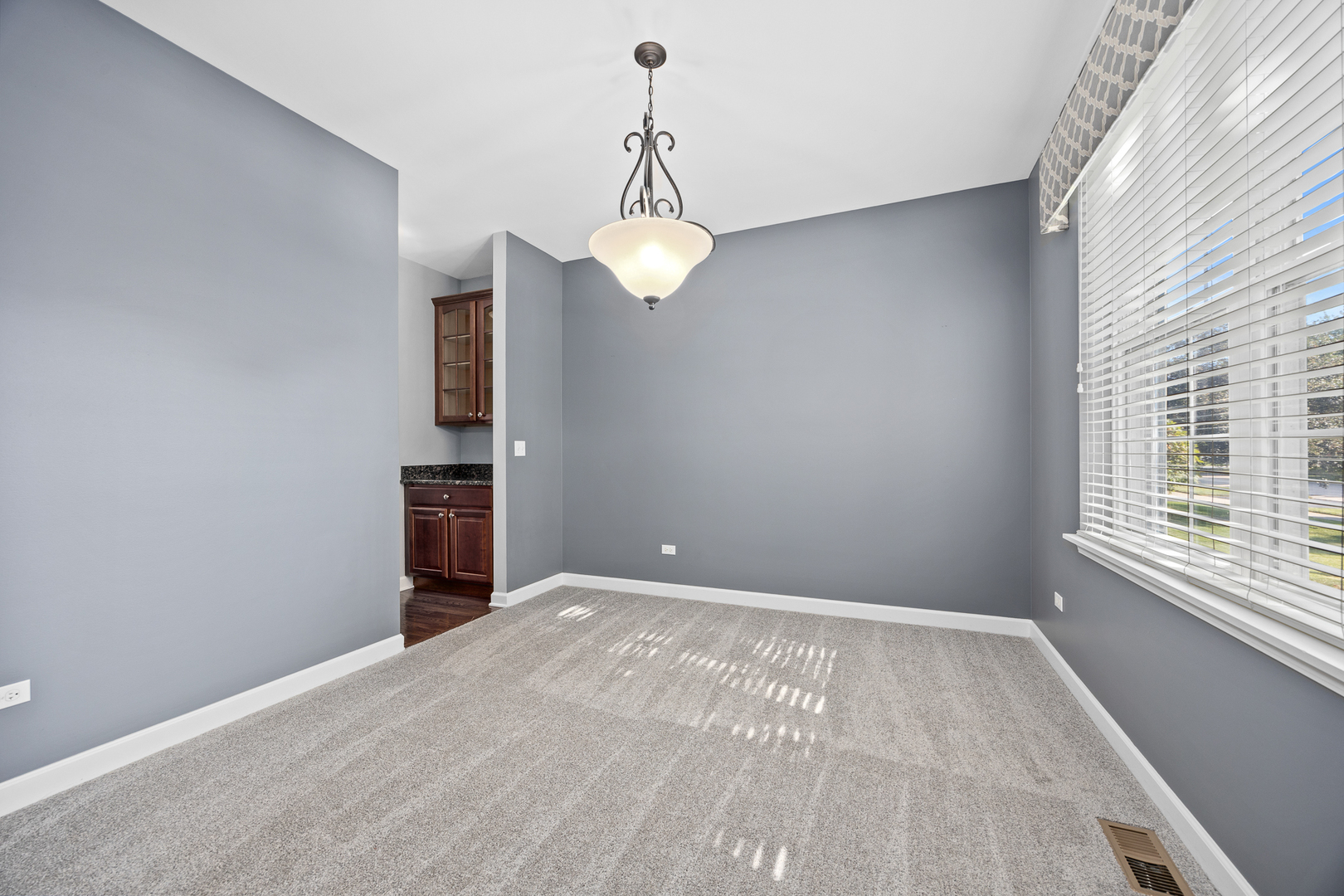 725 Delacourte Avenue Bolingbrook, IL 60490 - Photo 5 of 38 a view of an empty room with a window