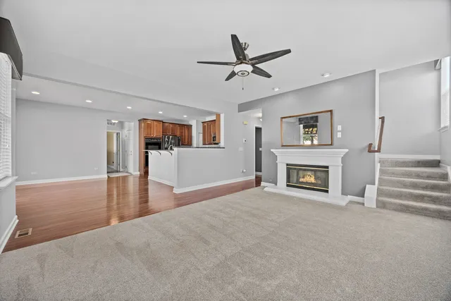 a view of a livingroom with a fireplace and window