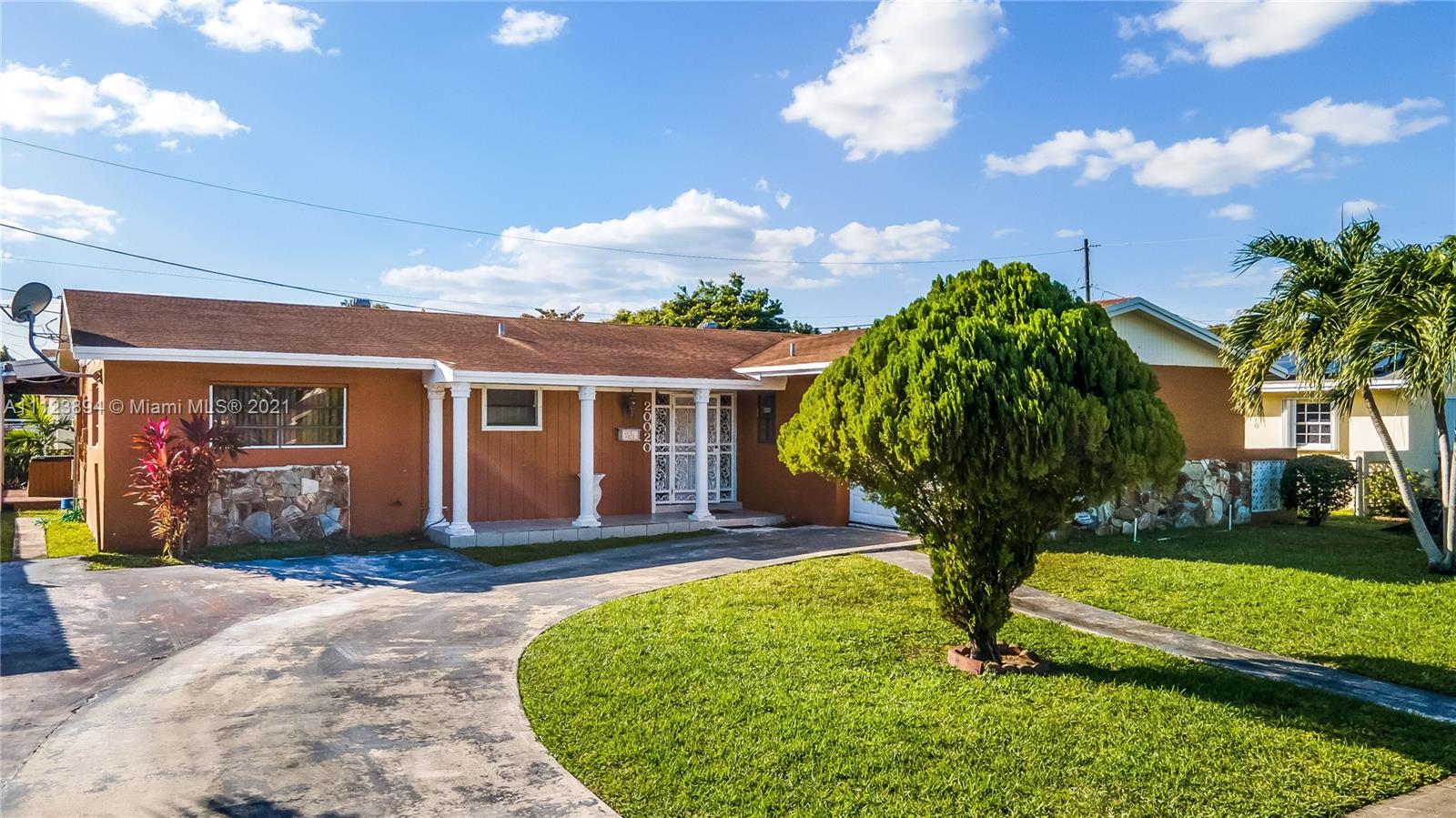 20020 Southwest 112th Avenue Miami, FL 33189 - Photo 1 of 39 a front view of a house with a yard