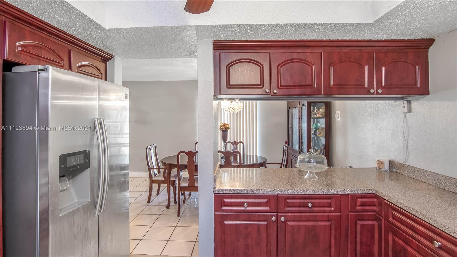 20020 Southwest 112th Avenue Miami, FL 33189 - Photo 13 of 39 a kitchen with stainless steel appliances granite countertop a refrigerator and microwave