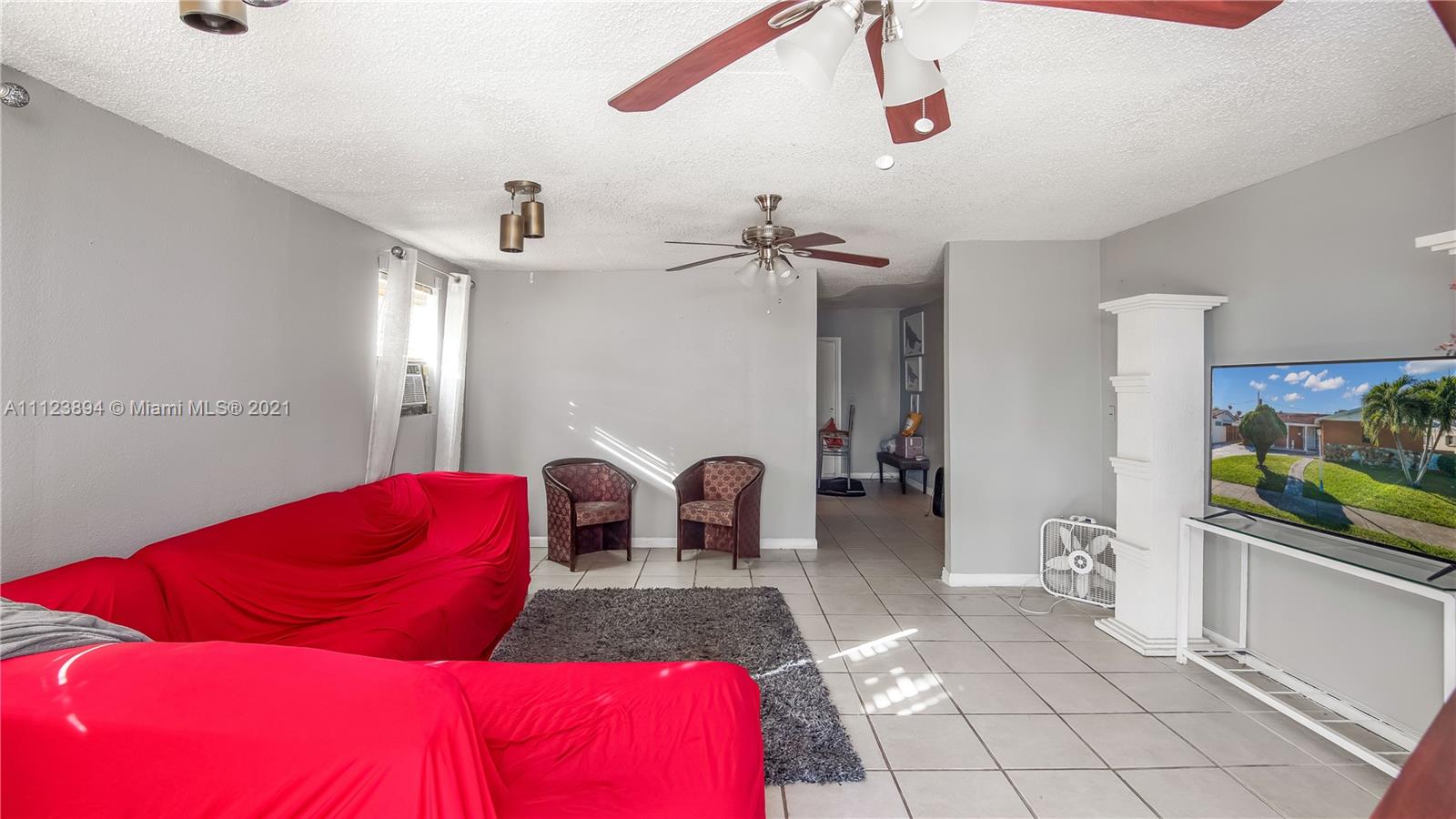 20020 Southwest 112th Avenue Miami, FL 33189 - Photo 20 of 39 a living room with furniture and a flat screen tv